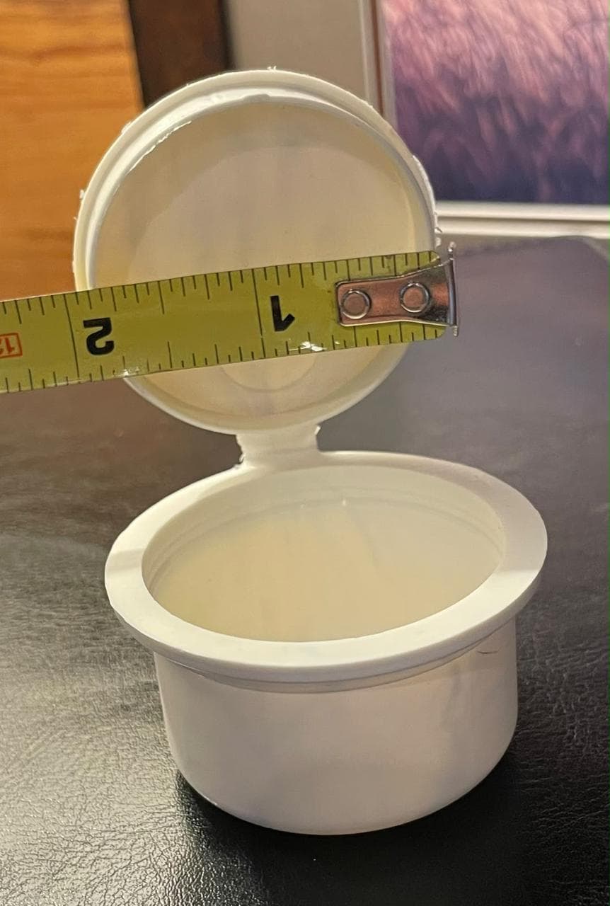 Hinged pop top container showing child-resistant closure mechanism
