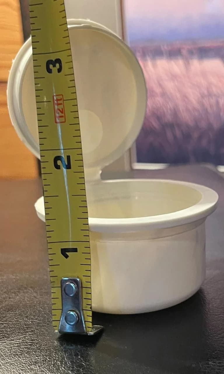 PHA pop top container measured for height with a tape measure